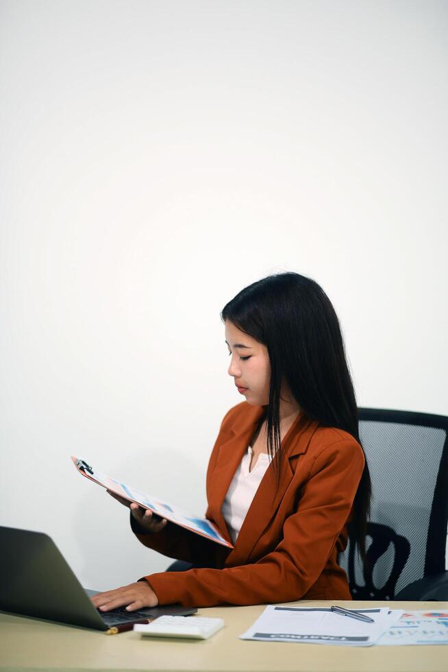 A driven and dedicated young professional showcases her efficiency and attention to detail as she works diligently on her laptop photo
