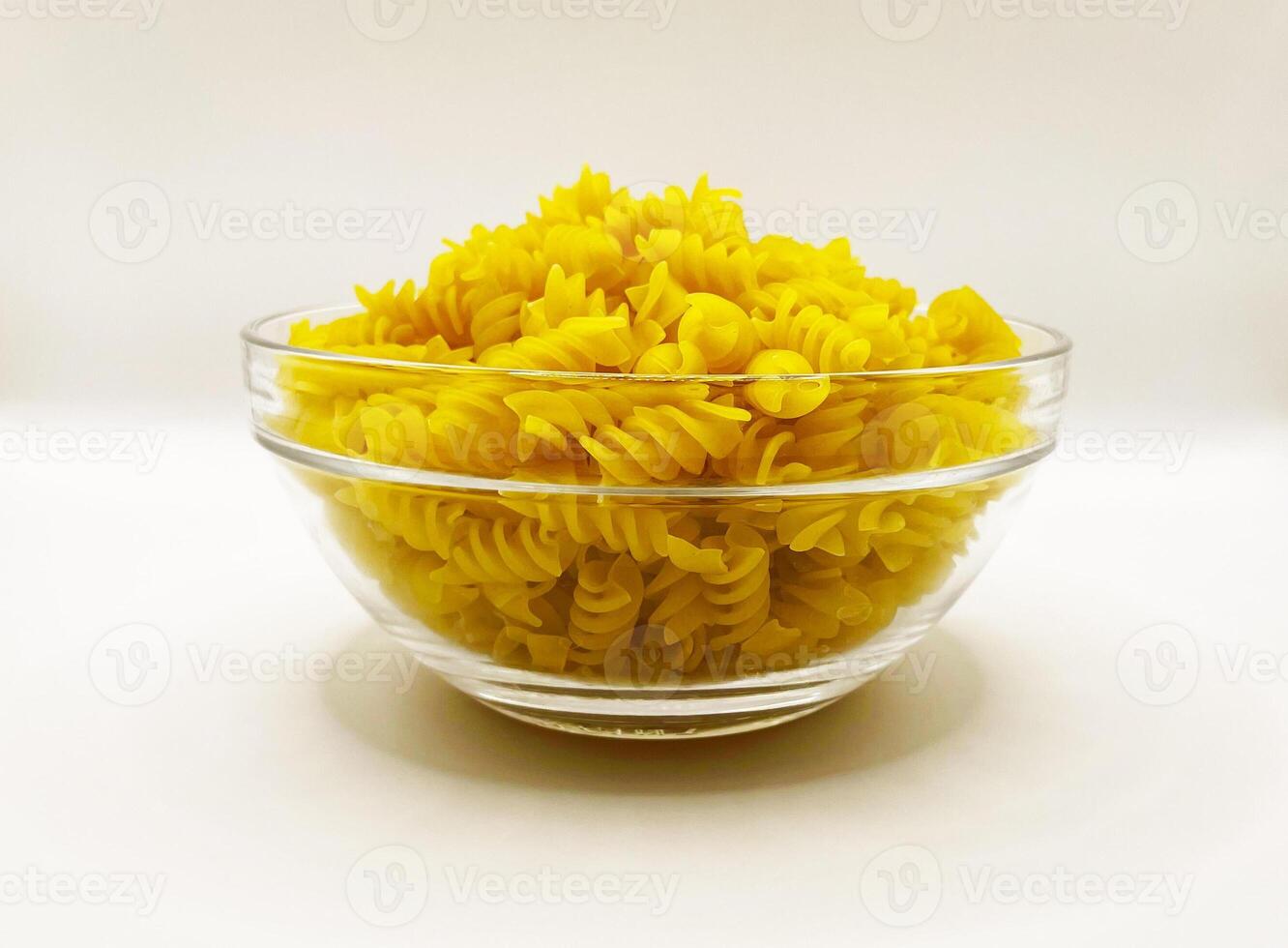 Pasta in a plate on a white background. A portion of pasta photo