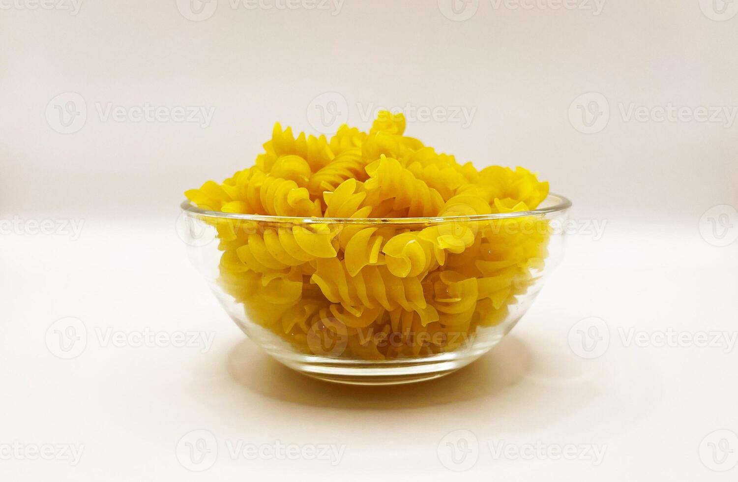 Pasta in a plate on a white background. A portion of pasta photo