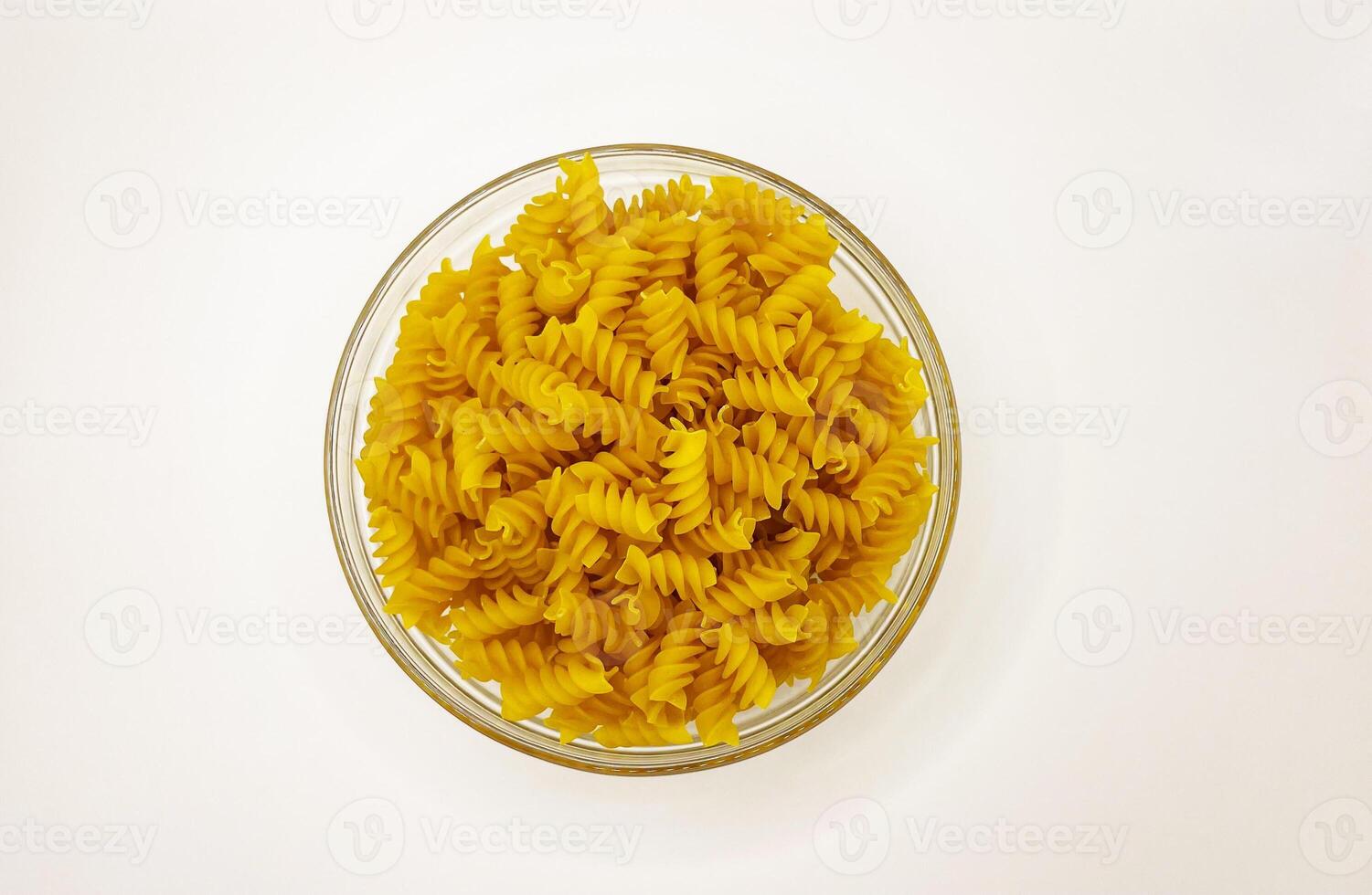 Pasta in a plate on a white background. A portion of pasta photo