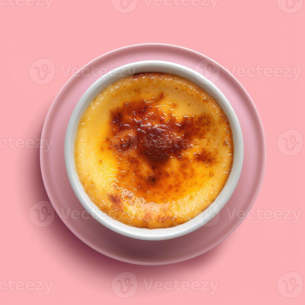 Closeup of a delicious creme brulee dessert with a crispy caramelized sugar topping, served on a pink saucer. Sweet treat, French cuisine, bakery, dessert, food photography. photo
