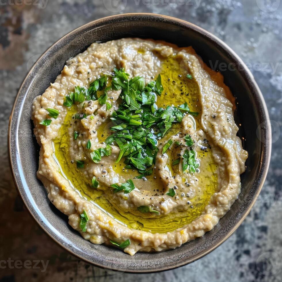 Bowl of Creamy Baba Ganoush with Parsley and Olive Oil photo