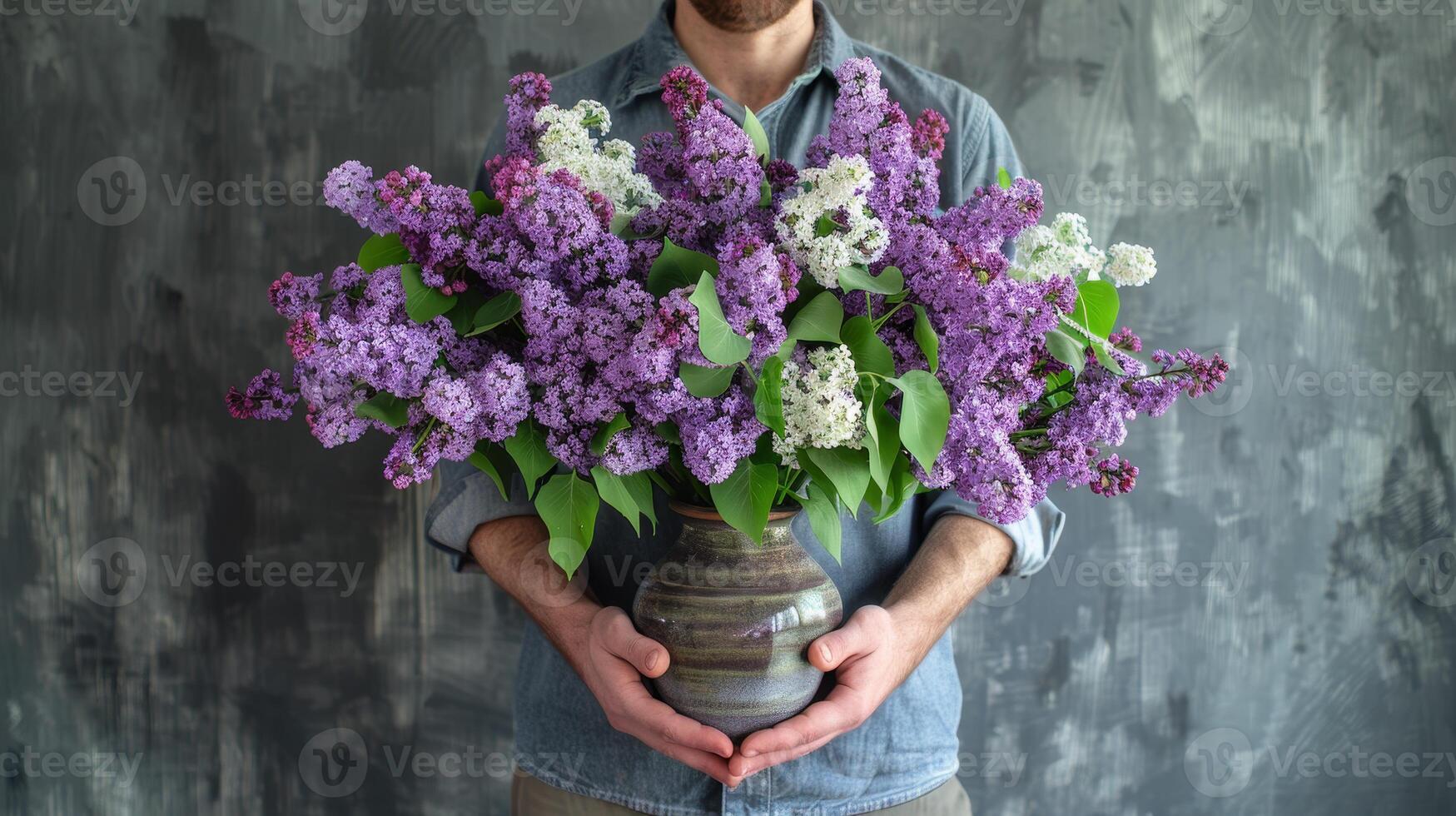 Elegant Man Holding Vibrant Lilacs in Studio Setting photo