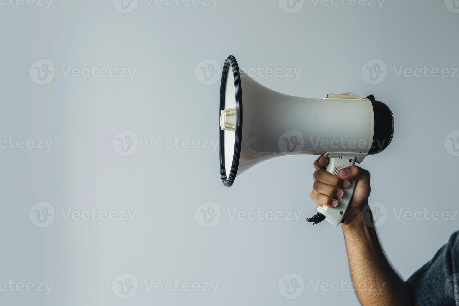 Hand holding a megaphone on a white background photo
