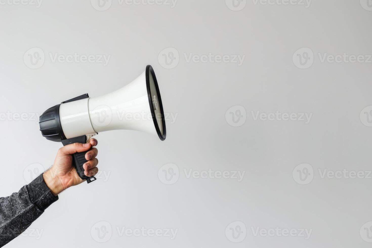Hand holding a megaphone on a white background photo