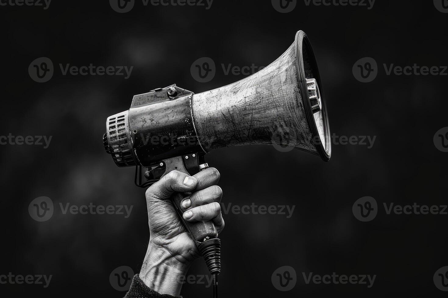 Vintage megaphone in hand raised in protest photo