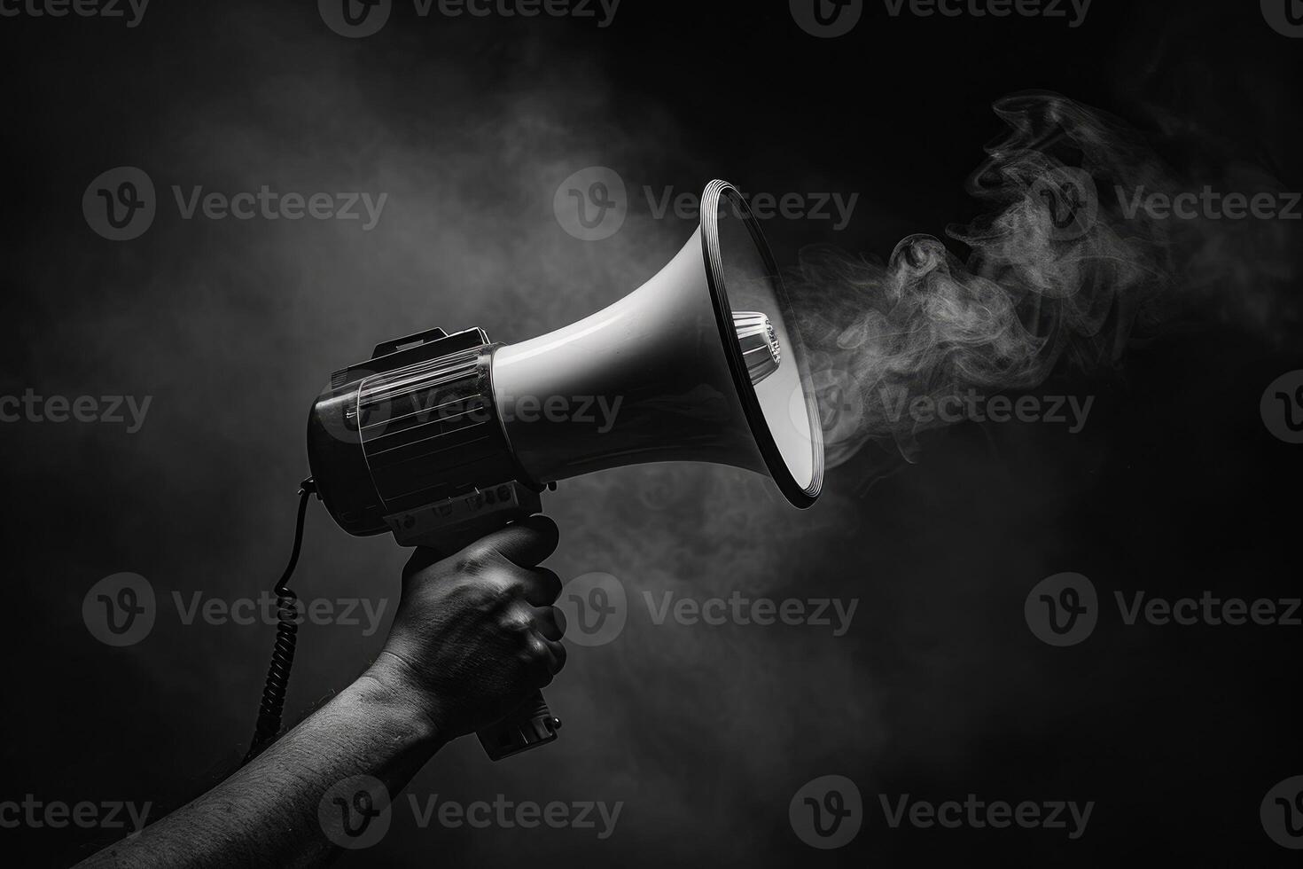 Smoke billows from a megaphone held in a hand with a dark background photo