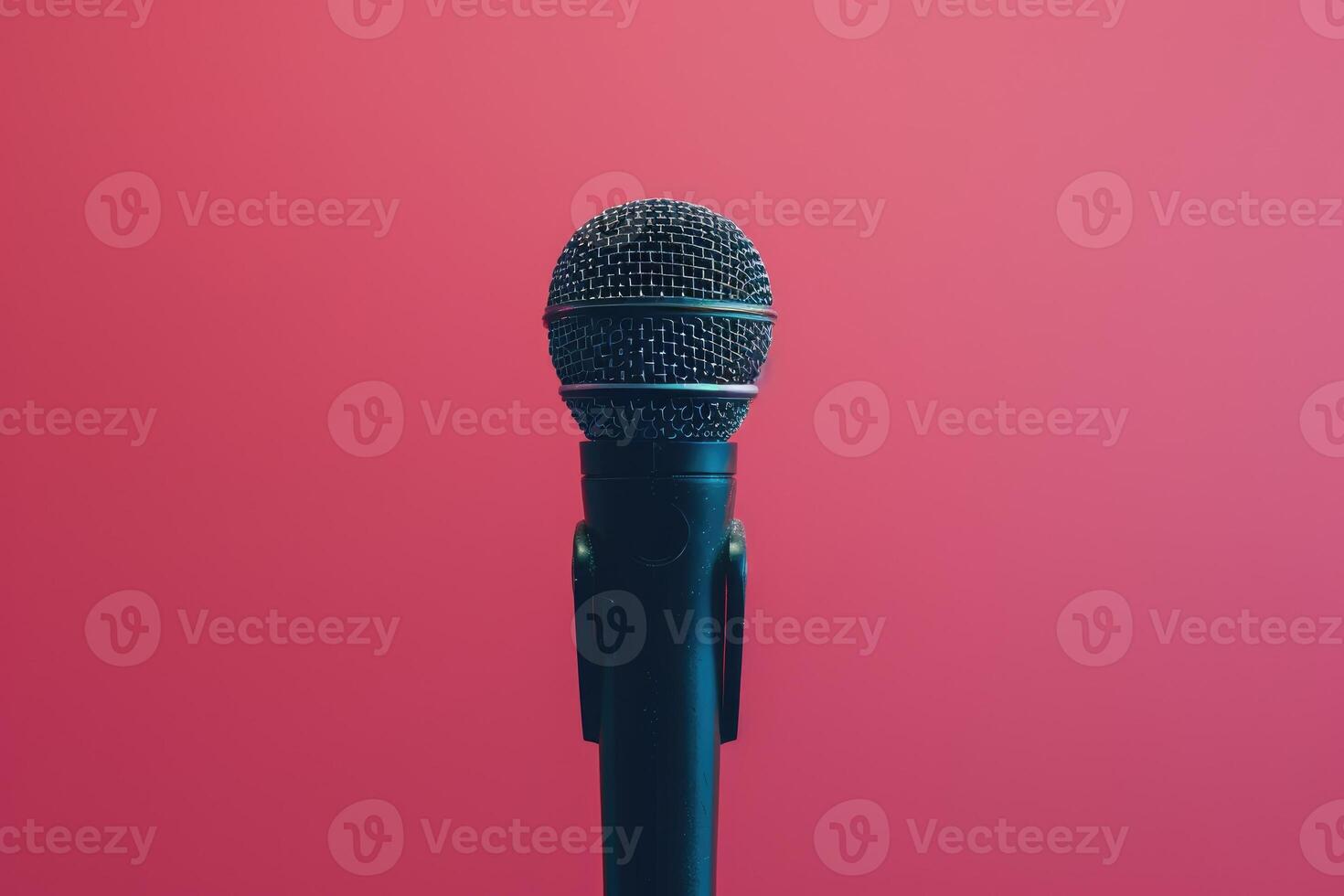 Close up of a microphone on stage with pink background lights photo
