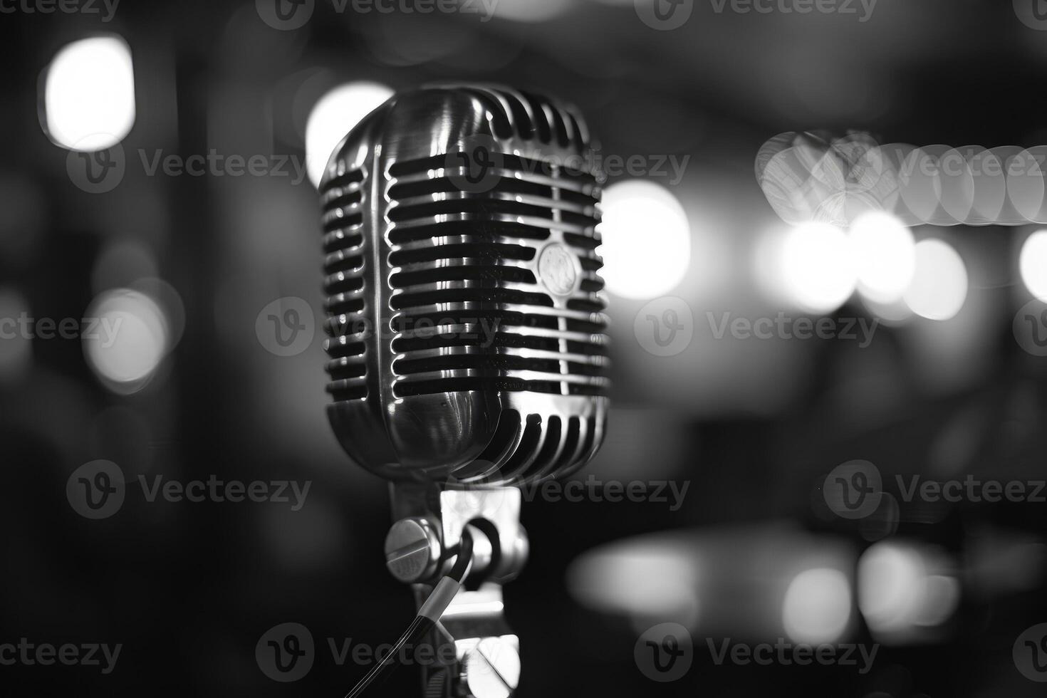 Close up of a vintage microphone on stage with blurred background lights photo