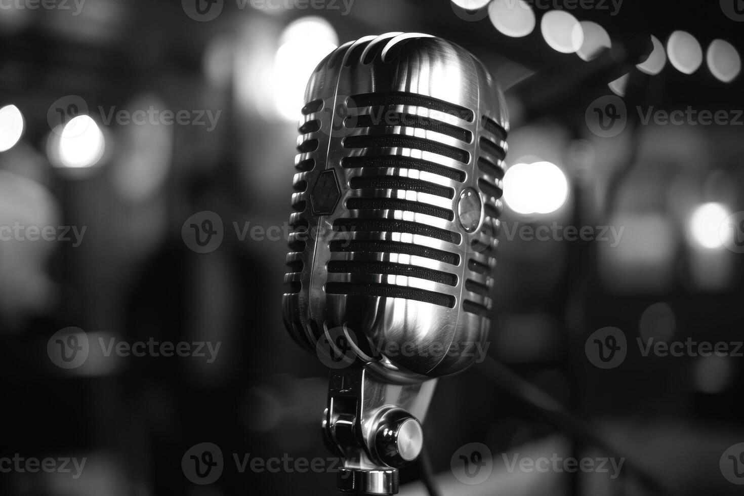 Close up of a vintage microphone on stage with blurred background lights photo