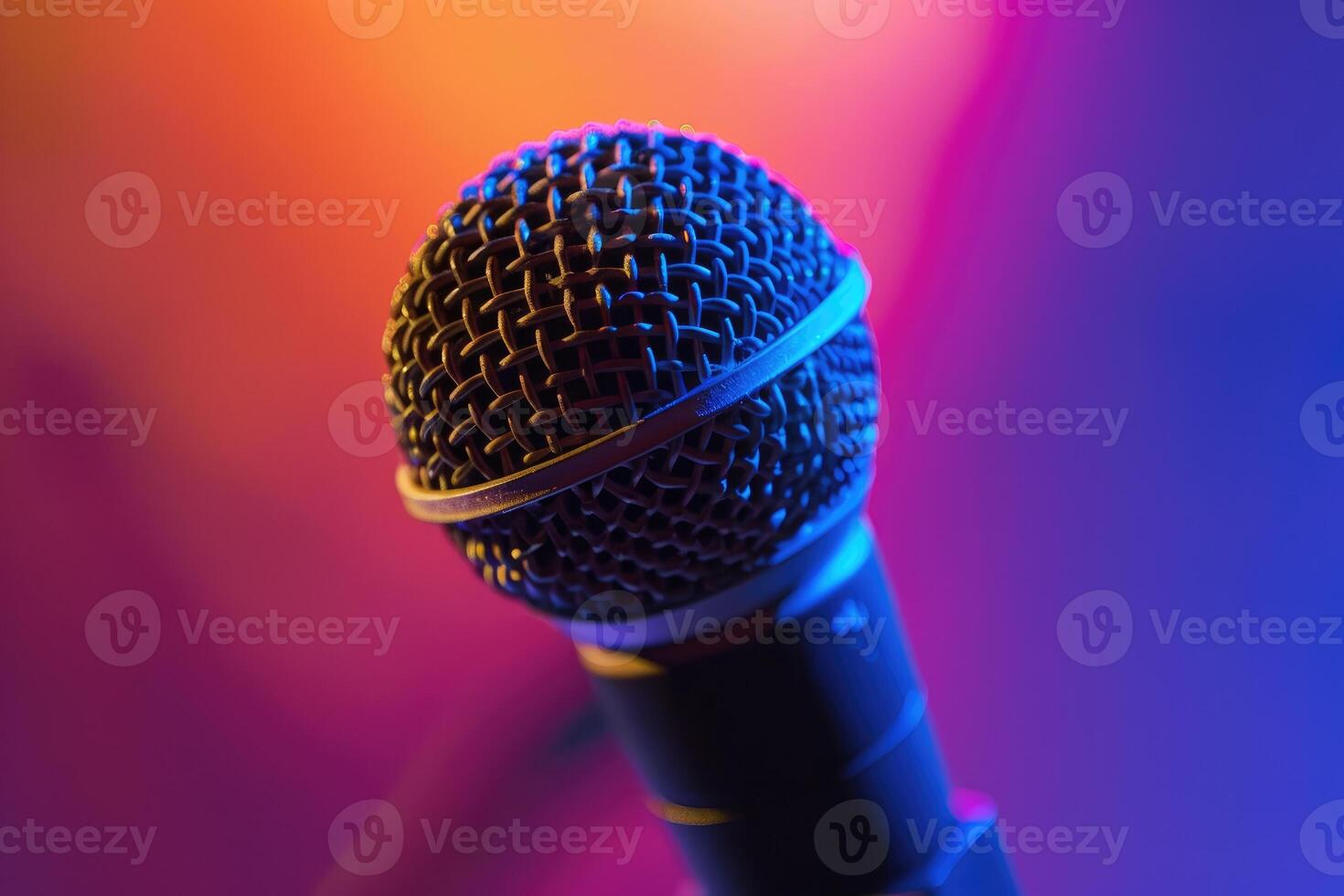 Close up of a microphone on stage with colorful blurred background lights photo