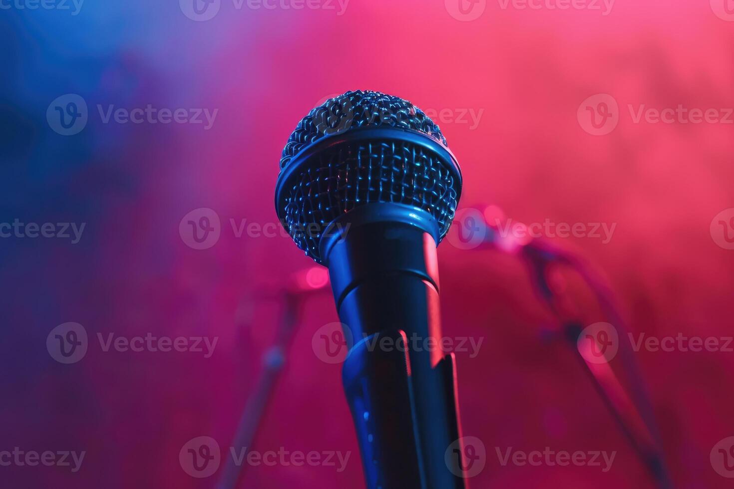 Close up of a microphone on stage with a colorful background photo