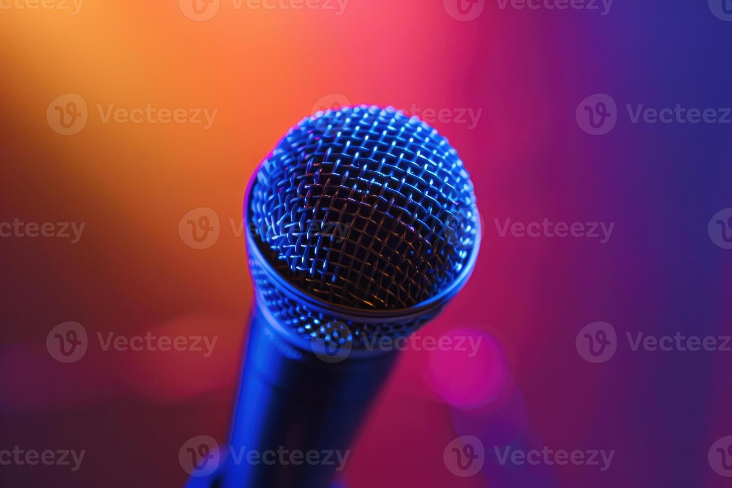 Close up of a microphone on stage with colorful blurred background lights photo