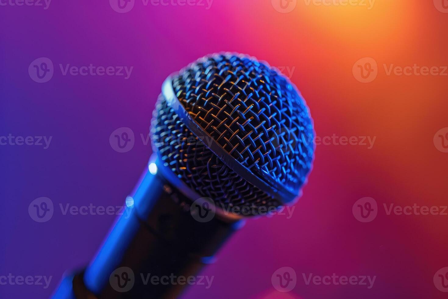 Close up of a microphone on stage with colorful blurred background lights photo
