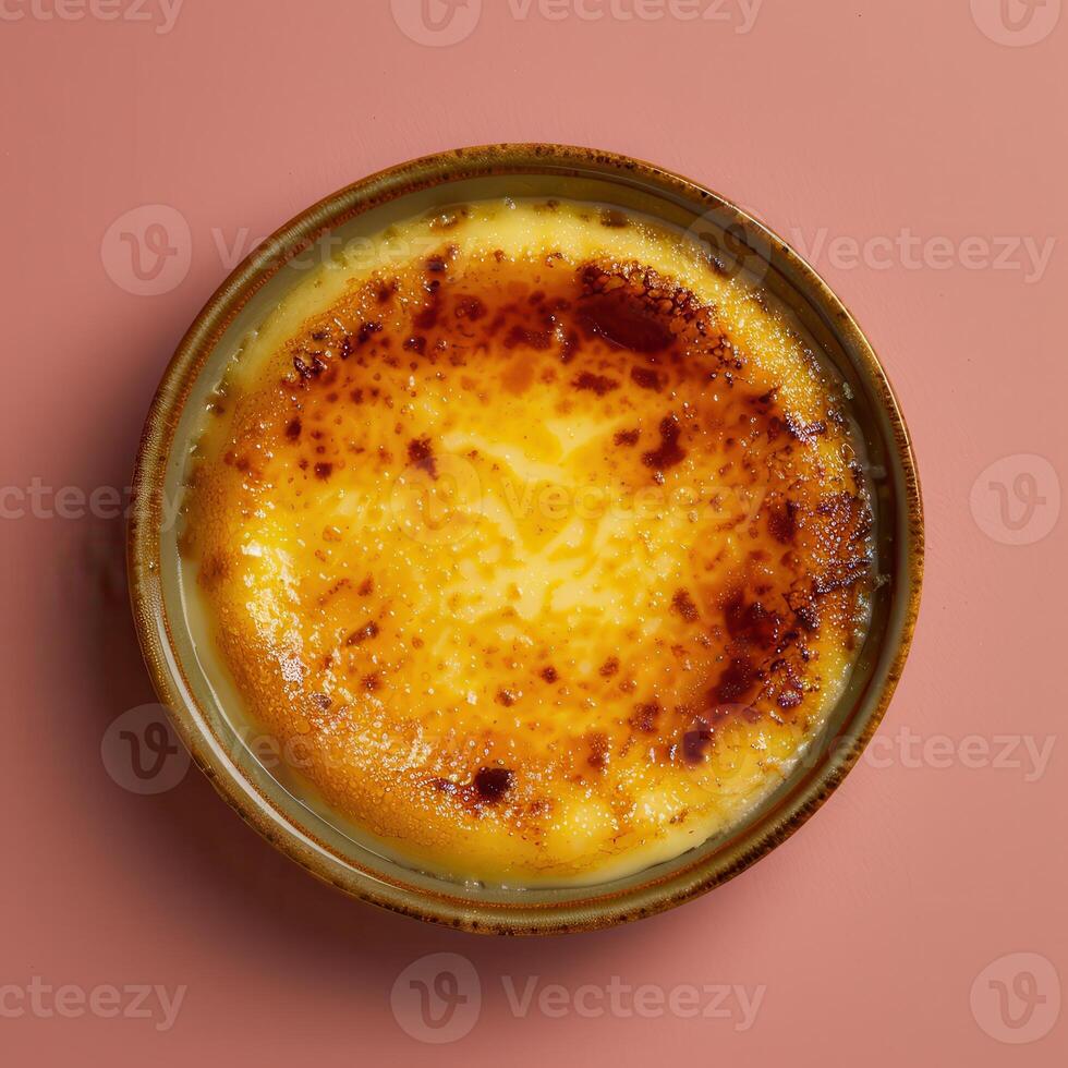 Close-up of creamy, golden-brown creme brulee with a crispy caramelized sugar topping in a ramekin. French dessert, food photography. photo