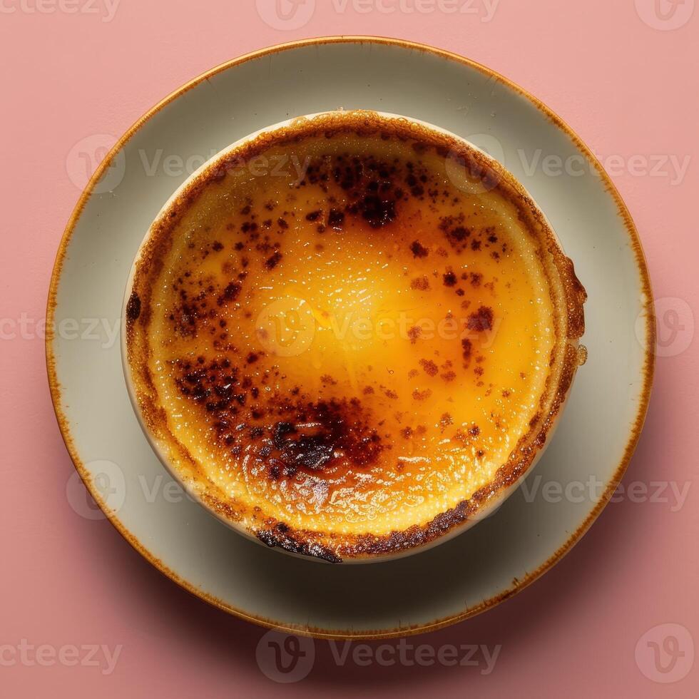 Close up of a single serving of creamy creme brulee with a perfectly caramelized top. Gourmet dessert for a romantic dinner or special occasion. photo