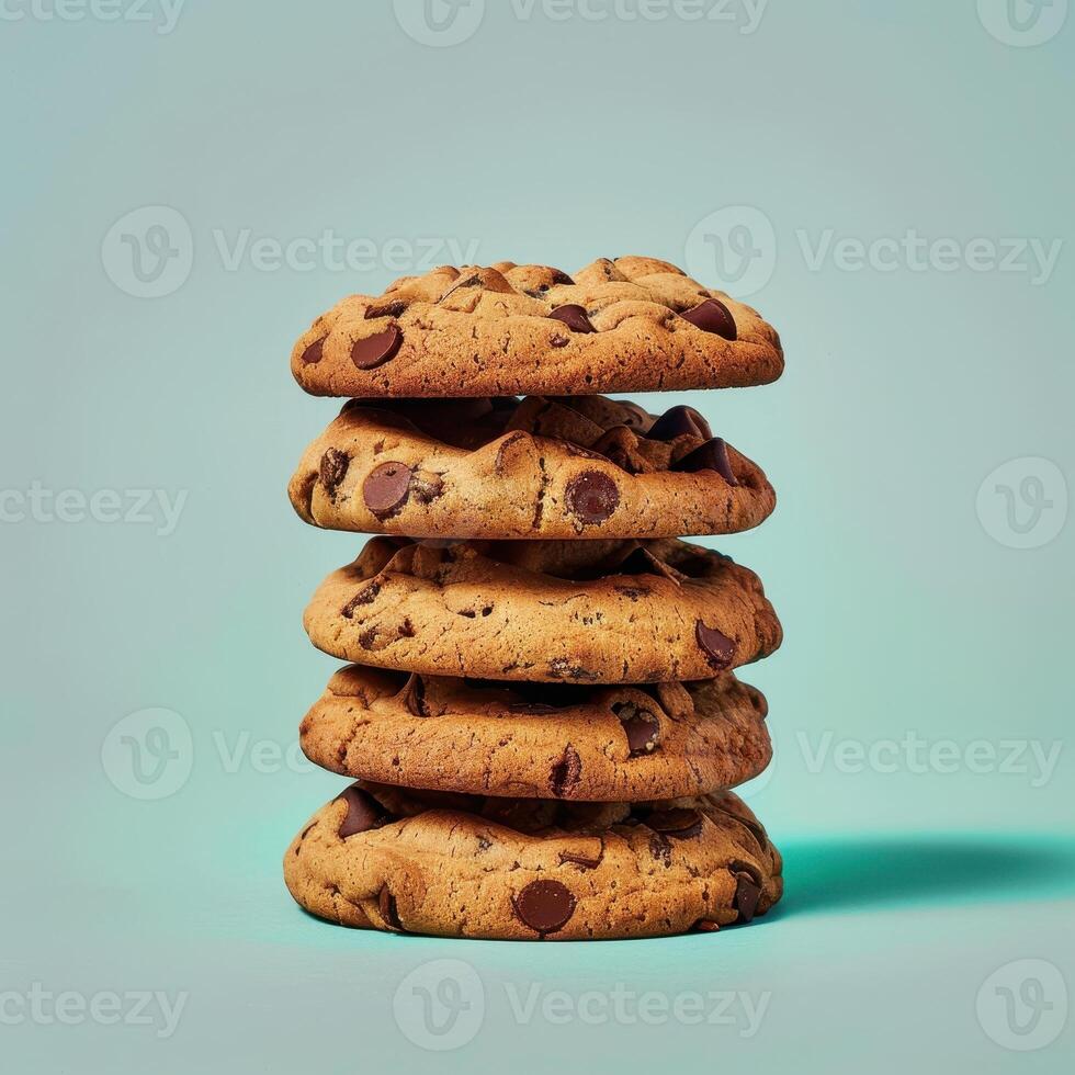 Stack of five delicious chocolate chip cookies on blue background. Concept of sweet treats, dessert, snack time, bakery, and comfort food. photo