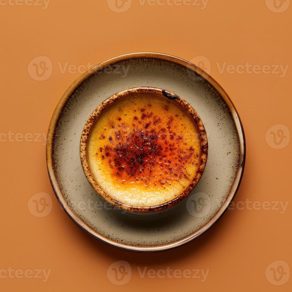 Close-up of a delicious creme brulee with a caramelized sugar crust. A classic French dessert recipe. photo