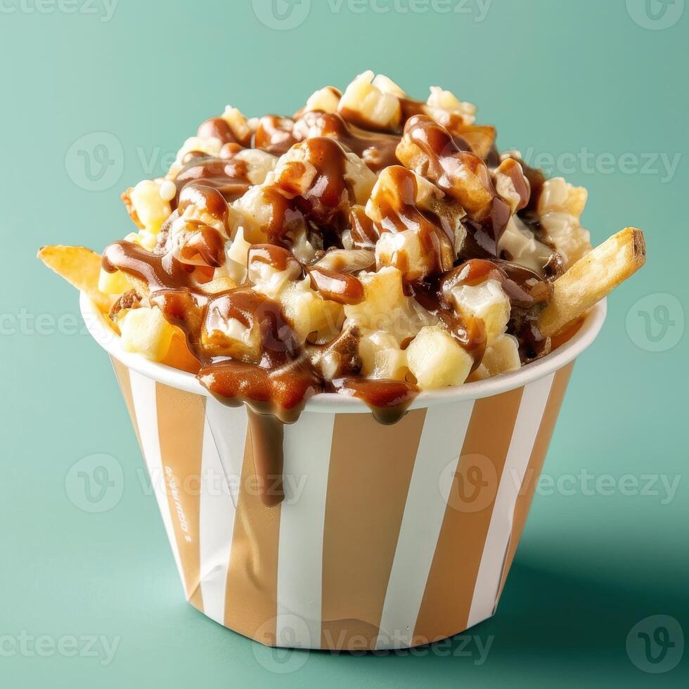Closeup of delicious poutine, a Canadian dish of french fries topped with cheese curds and gravy. Classic comfort food. photo