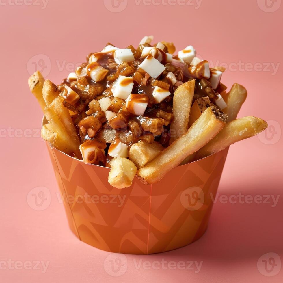 Poutine, a popular Canadian dish of french fries, cheese curds, and gravy. Close-up view of a portion of poutine in a paper cup. photo