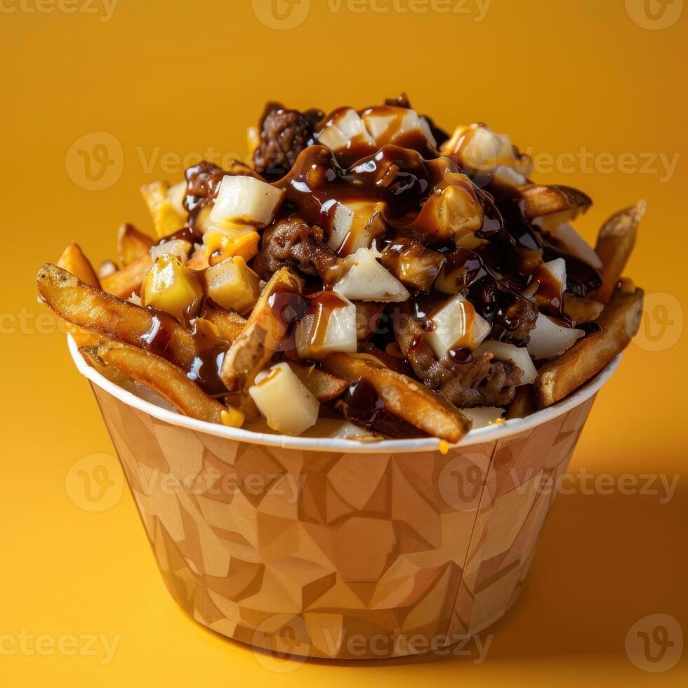 Poutine with beef gravy, cheese curds, and onions in a paper bowl. Canadian comfort food. Delicious and messy. photo