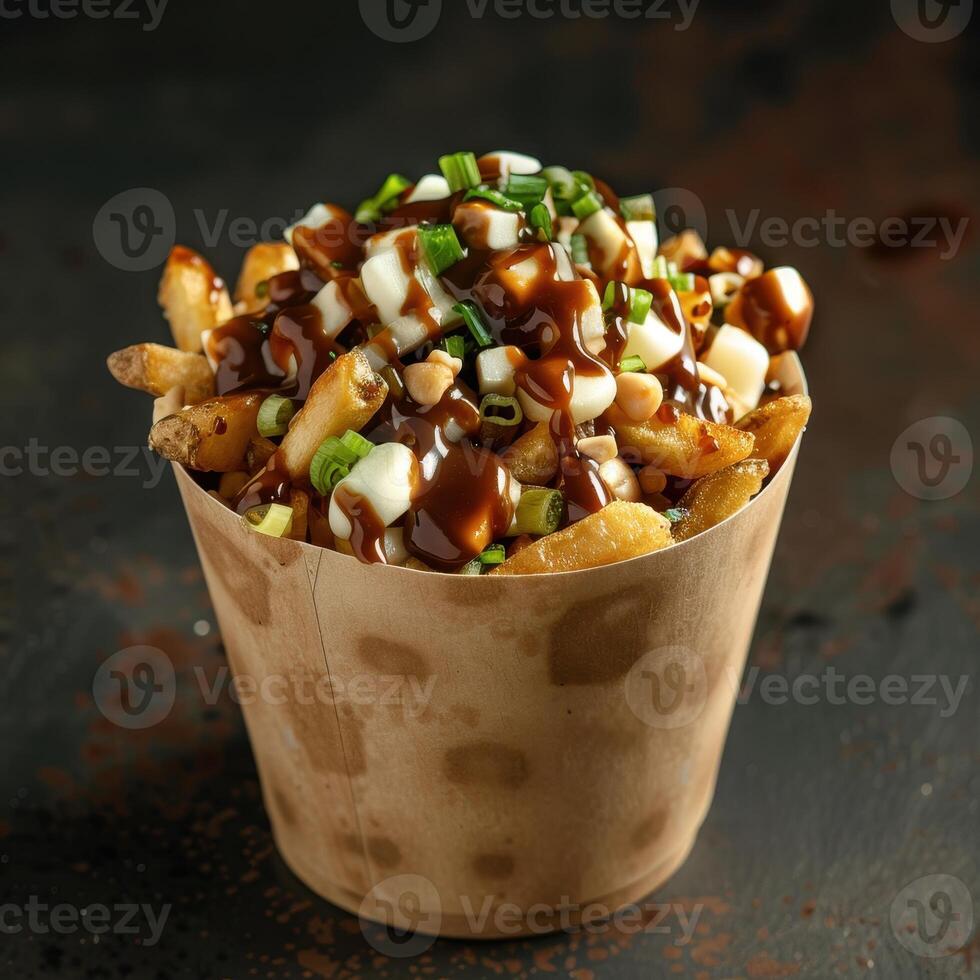 Close up of Poutine in a paper container with cheese curds, gravy, and fries. Classic Canadian comfort food on a dark background. photo
