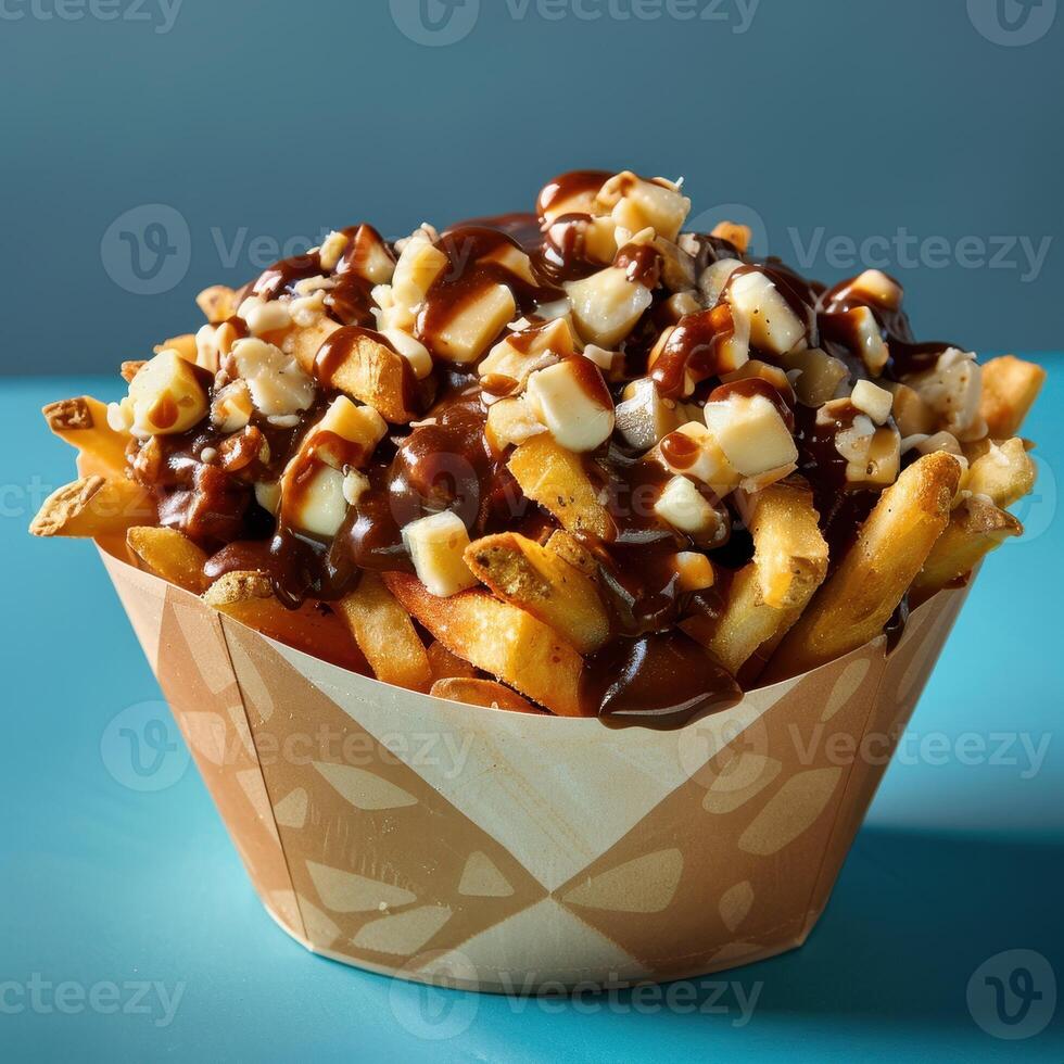 Closeup of a delicious poutine with fries, cheese curds and gravy. Canadian food concept. photo