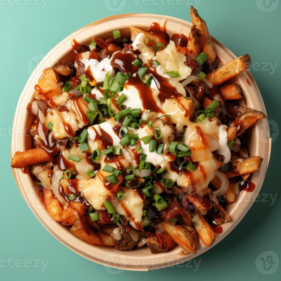 Close up of delicious poutine with cheese curds, gravy, and onions, served in a biodegradable bowl. Fast food photography of Canadian comfort food. photo