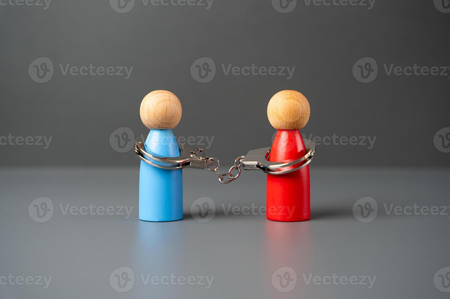 Two people are handcuffed. Bound by agreements and promises. The power of one over the other. Slavery and obedience. Freed from shackles. Break off relationships, stop business. photo