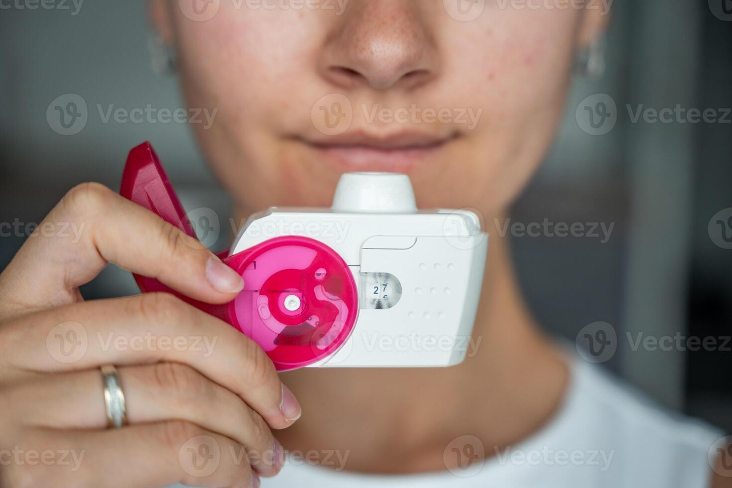 Close up view of woman using medicine dry powder inhaler for treatment asthma or COPD diseases. Pharmaceutical product is used to treat lung inflammation and prevent asthma attack. High quality photo