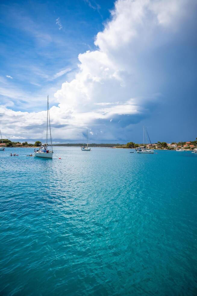 Uvala Gradina, Croatia - July 5, 2024. Yachts moored on buoys near the shore in the bay of Uvala Gradina near the town of Vela Luka on the island of Korcula in Croatia. High quality photo
