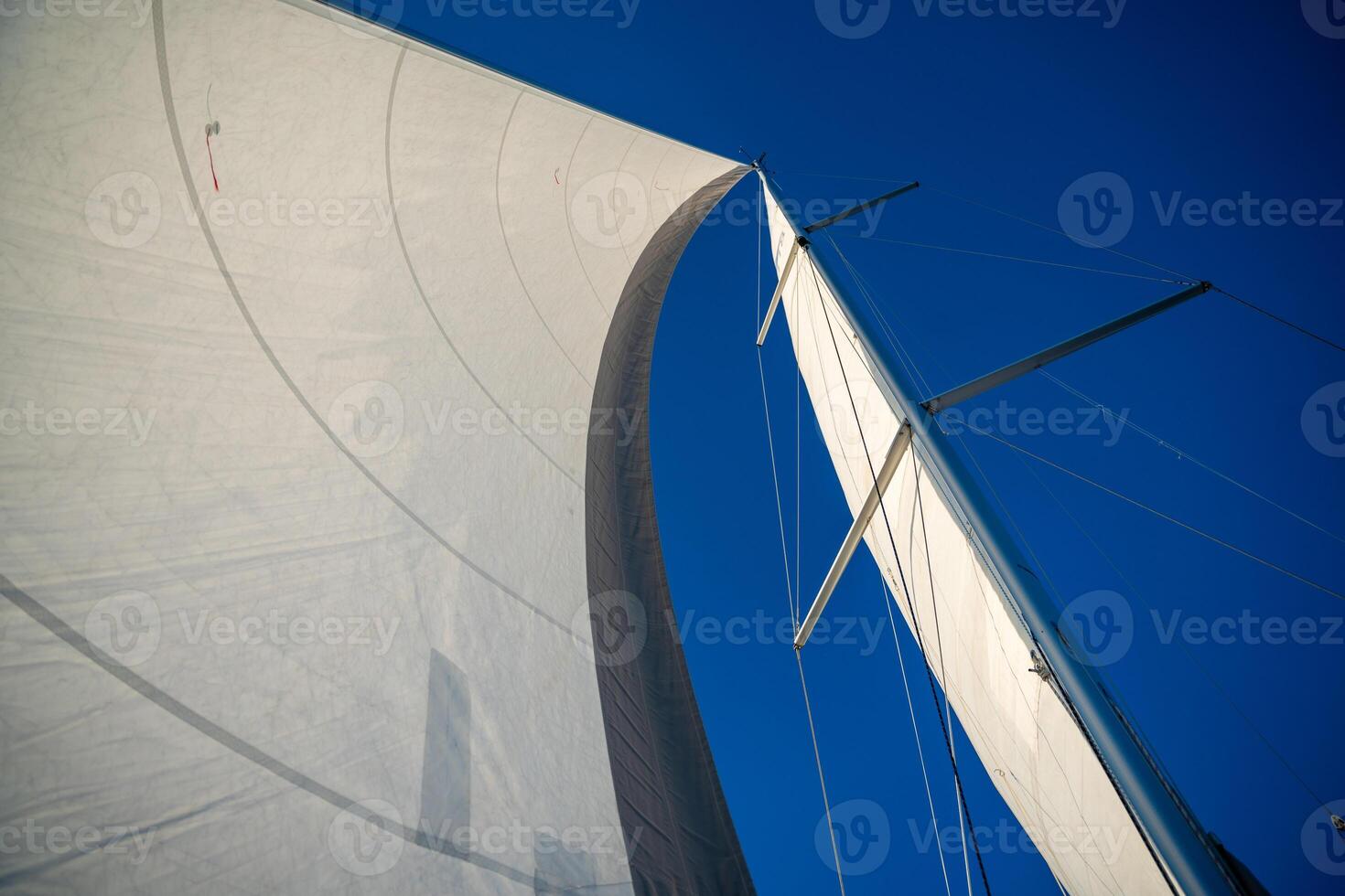 Sails of a sailing yacht in the wind sailing on the sea at sun light. High quality photo