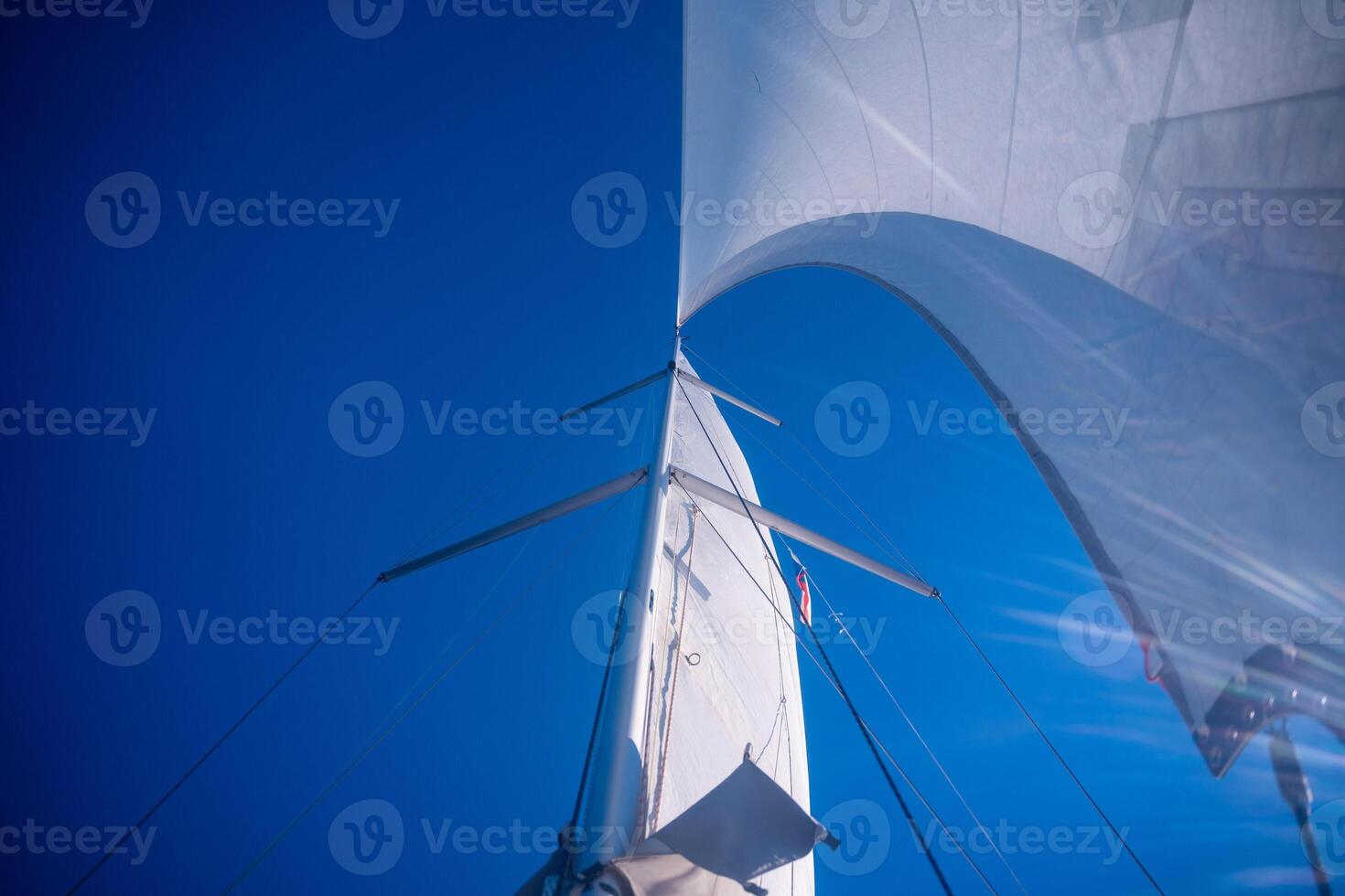 Sails of a sailing yacht in the wind sailing on the sea at sun light. High quality photo