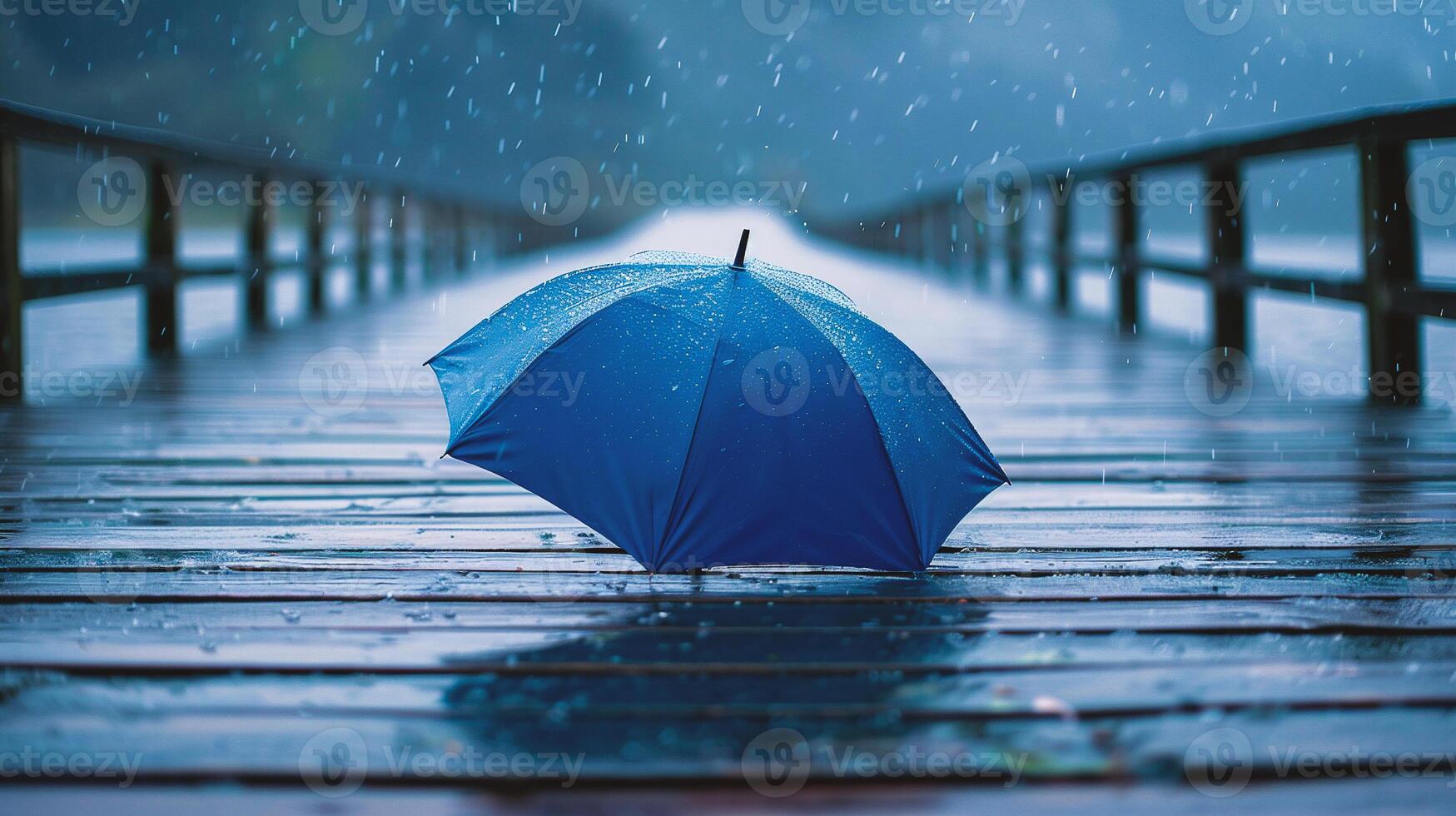 Blue umbrella on wooden pier in rainy day. Rainy weather concept photo