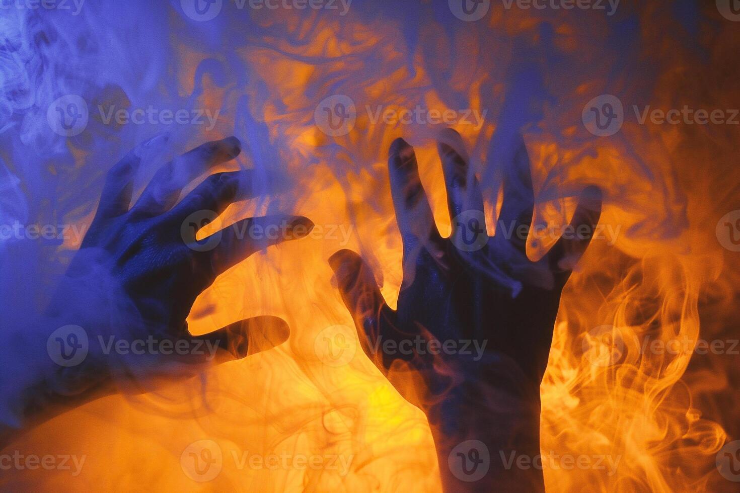 Hands of a man in a cloud of smoke and fire. photo