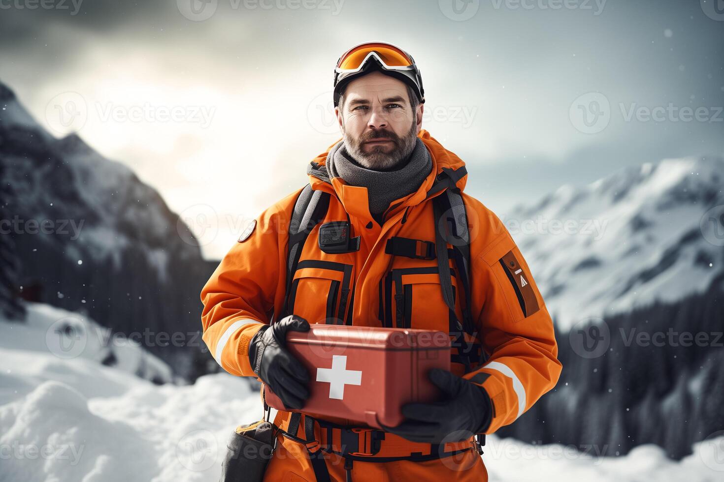 High-altitude medic in uniform holding an orange medical first aid kit on a snowy mountain slope photo