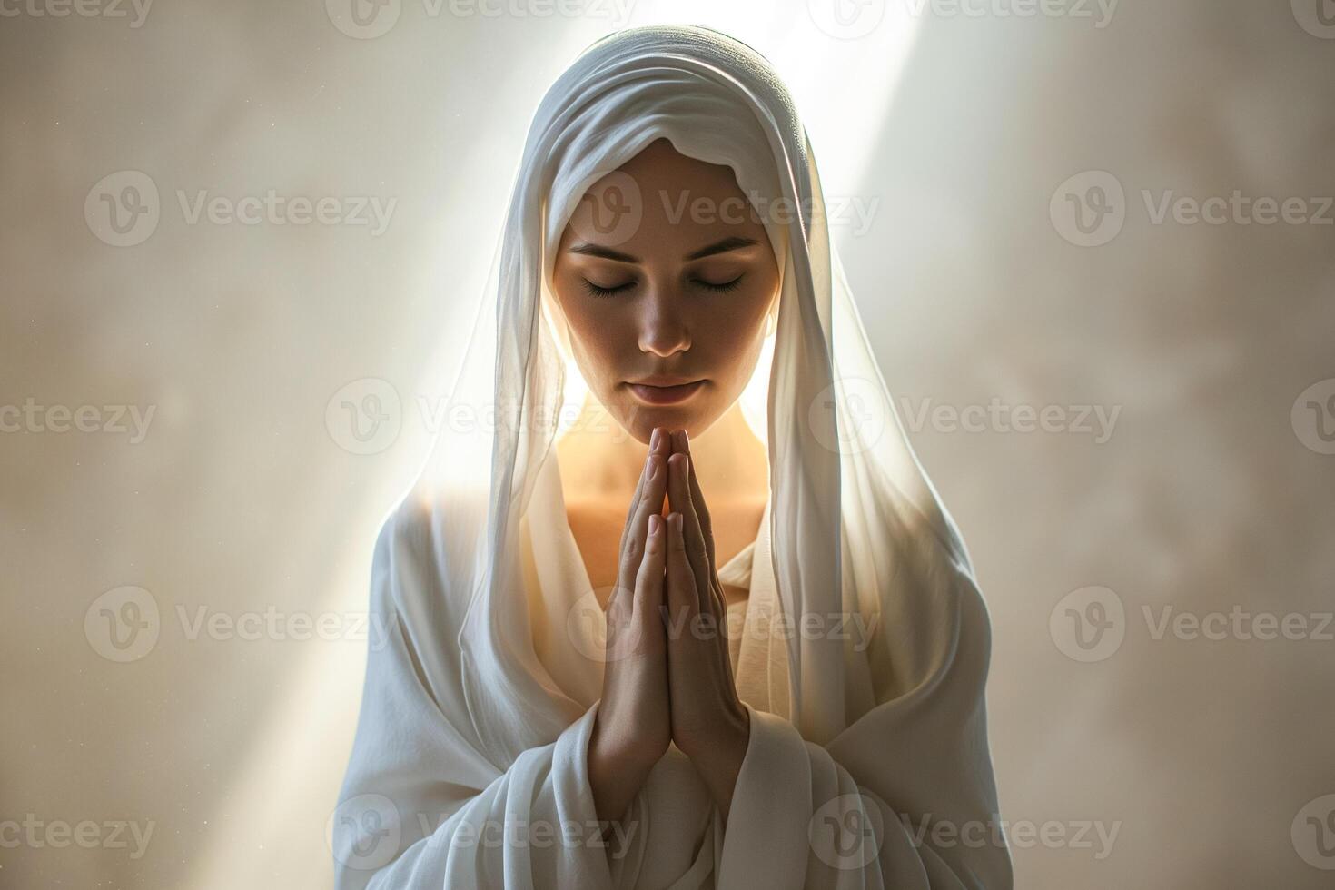 a young girl in a white stole folded her hands for prayer photo