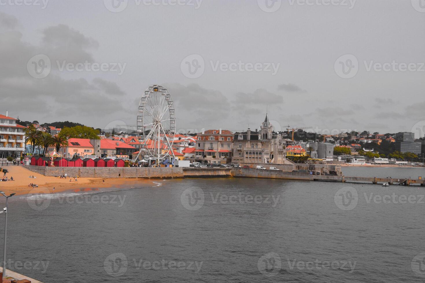 View of the Cascais embankment in Portugal. Sunny embankment with beautiful old buildings, Ferris wheel in Cascais, Portugal. photo