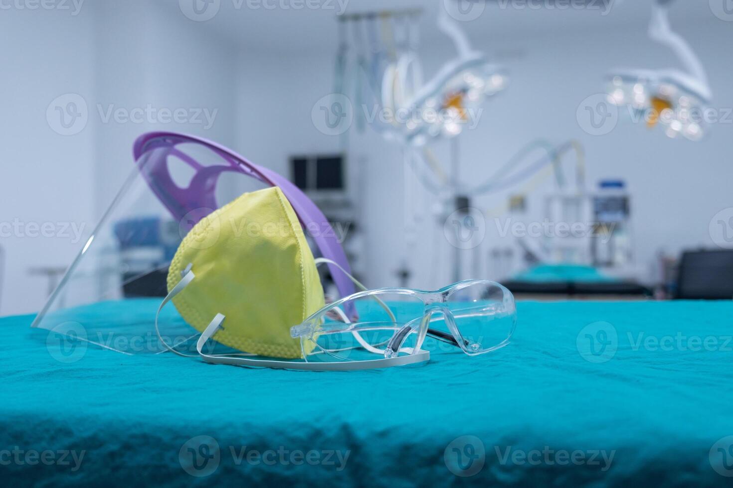Group of protective headwear for Doctor and Nurse such as surgical mask, face shield and safety glasses before surgery in operating room. photo