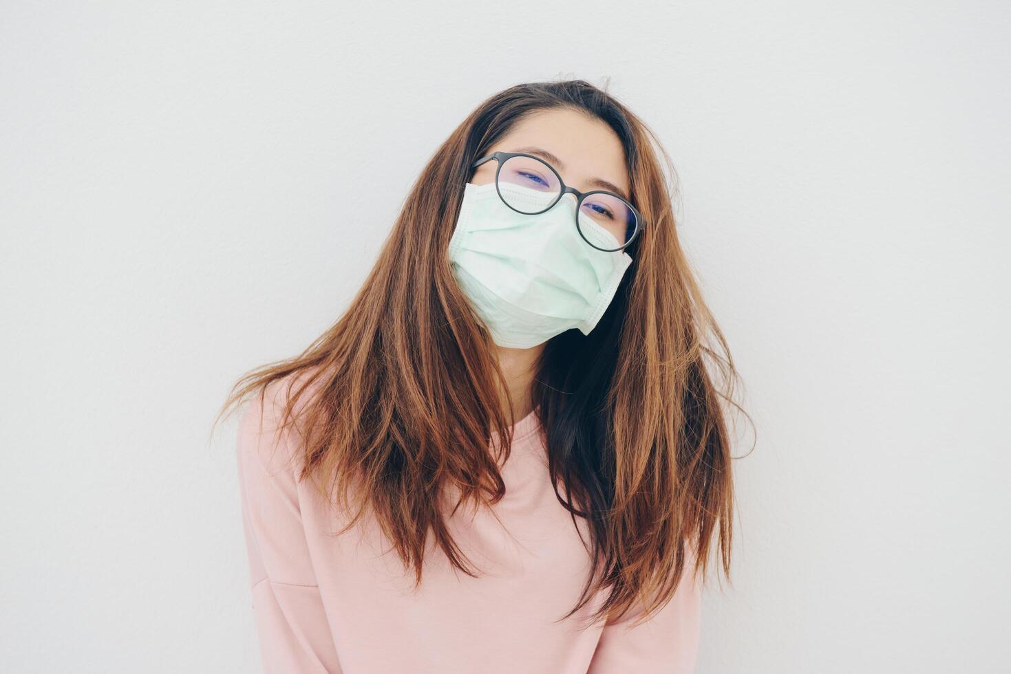 Portrait of sickness Asian woman wearing a mask to protect against infectious diseases from virus or bad pollution from PM2.5 smog. photo