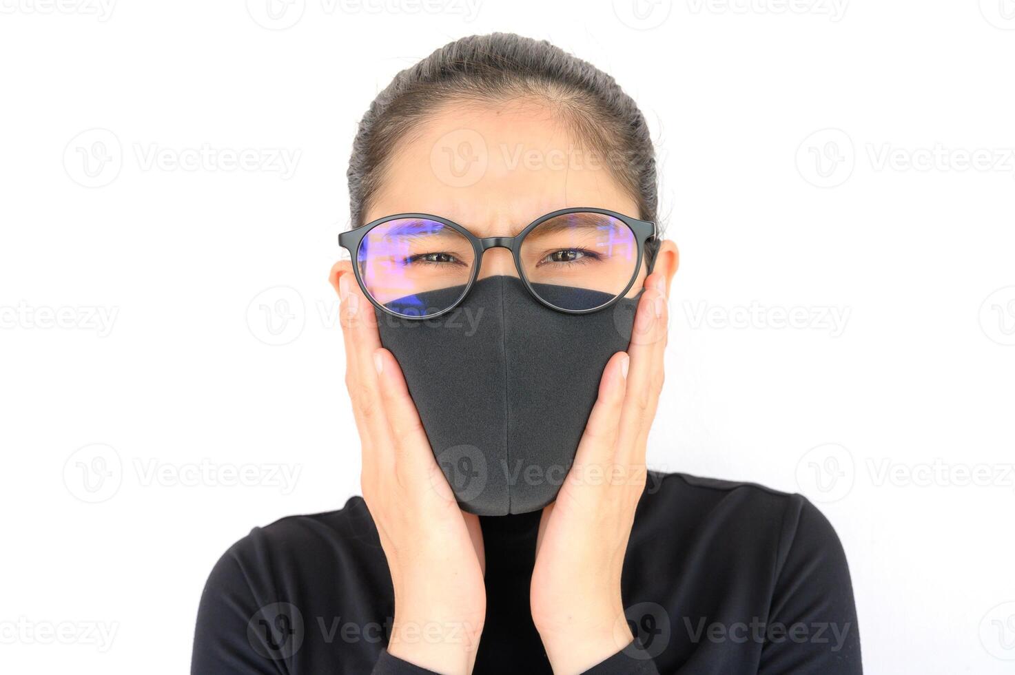 Close up of young Asian woman coughing and wearing black mask for protect bad air pollution. Air pollution has been associated with diseases of the heart and lungs, cancers and other health problems. photo