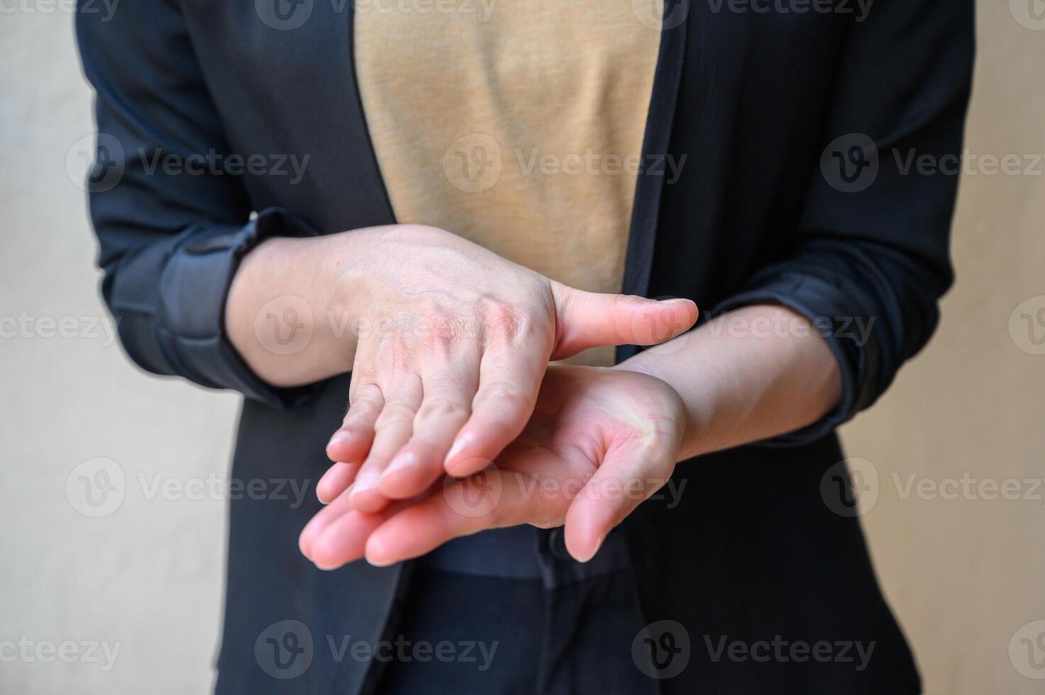 Cropped shot of woman showing hand washing techniques by rub palms together after using hand sanitizer gel. photo