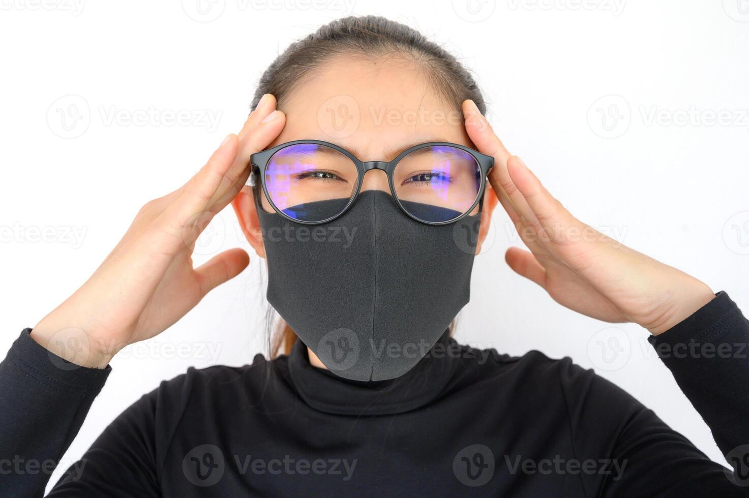 Young Asian woman feel headache and wearing black mask for protect bad air pollution. Air pollution has been associated with diseases of the heart and lungs, cancers and other health problems. photo