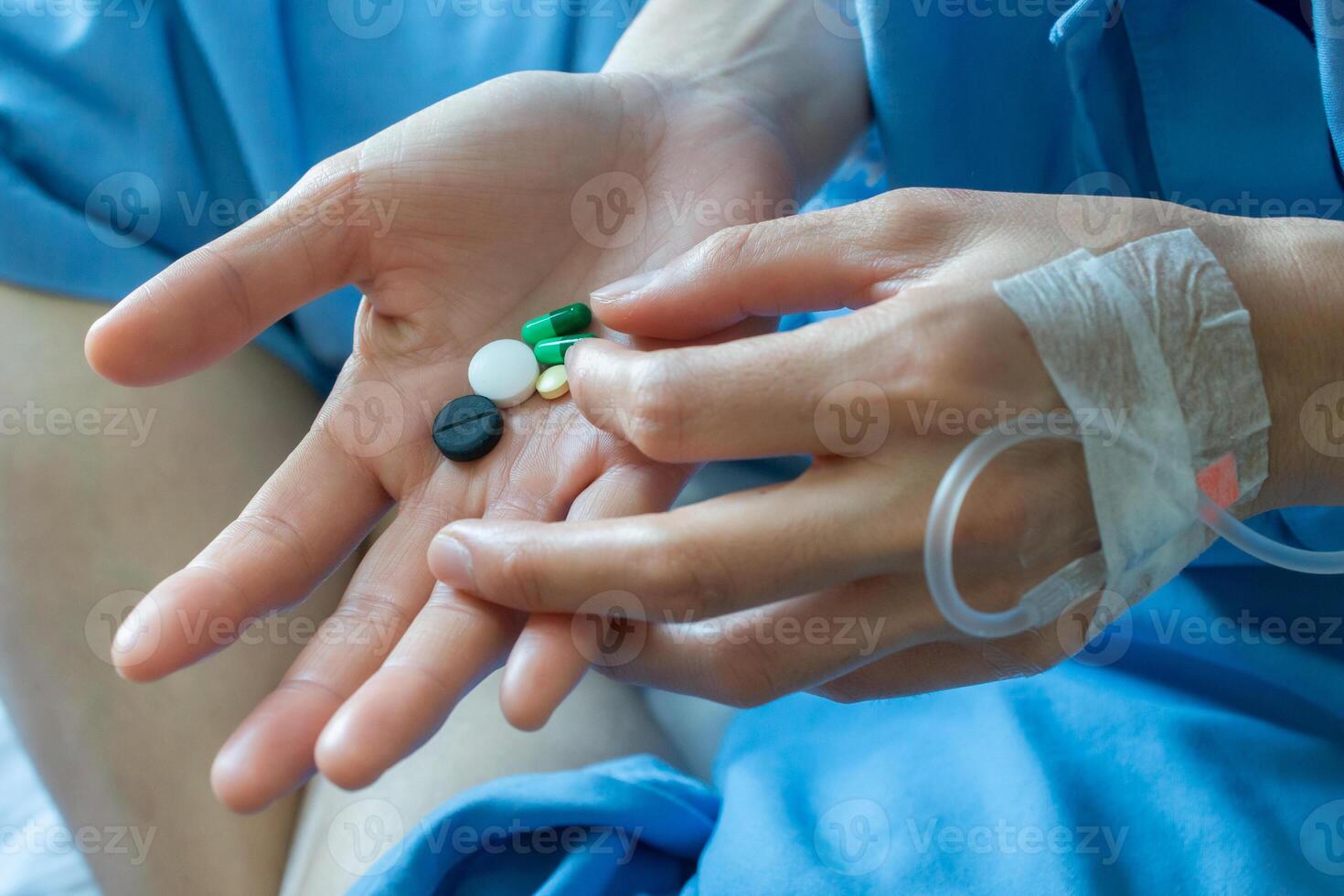 Cropped shot of patient holding medicines before eat it. Medicines are chemicals used to cure or prevent disease. photo