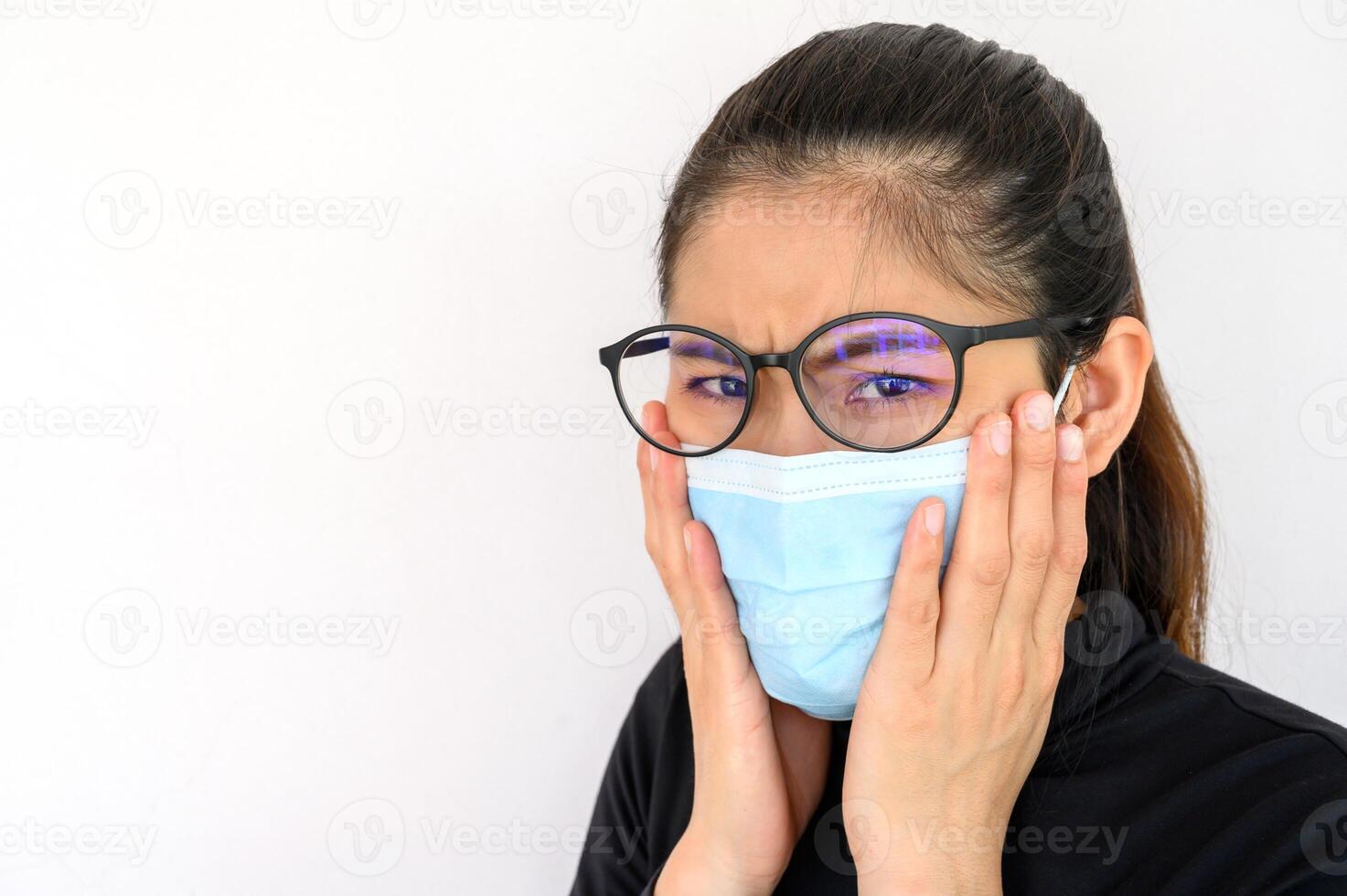 Close up of young Asian woman coughing and wearing mask for protect bad air pollution. Air pollution has been associated with diseases of the heart and lungs, cancers and other health problems. photo