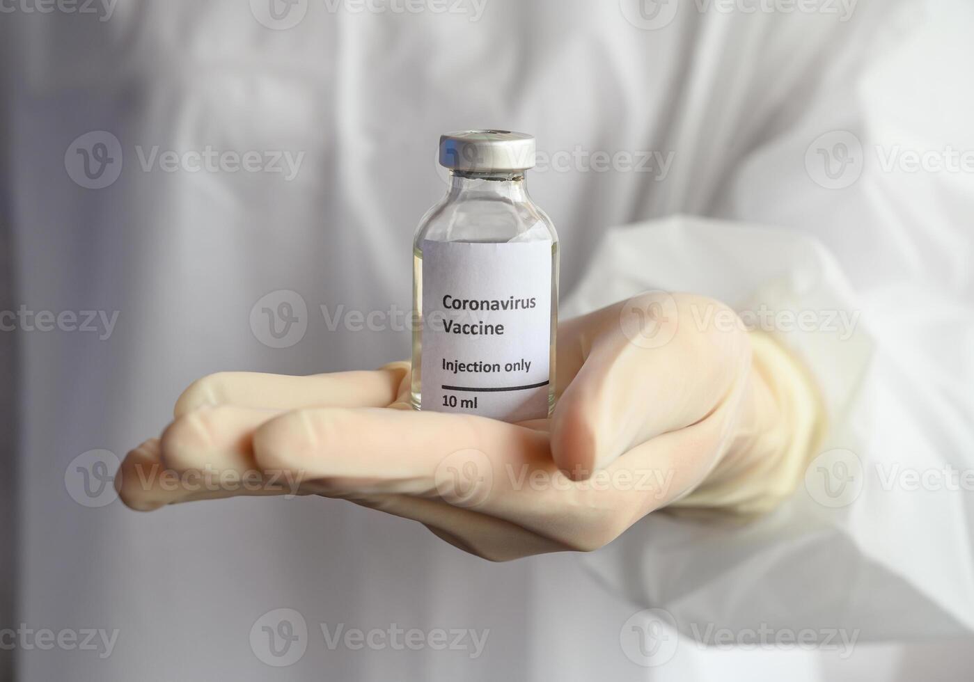 Close up of scientist doctor hand holding a sample test bottle of Covid-19 vaccine. photo