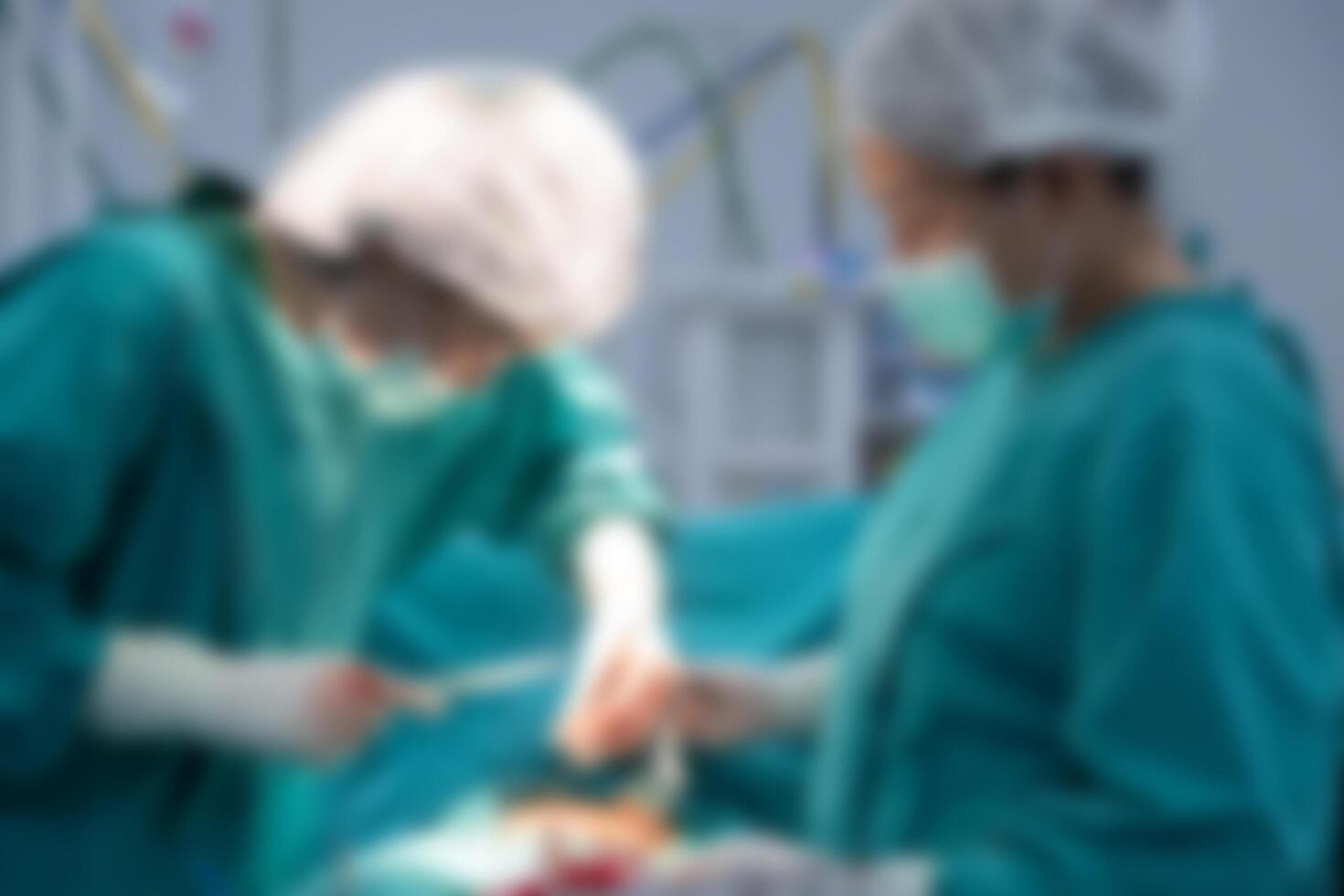 Blurred image background of medical team performing surgical operation in operating room. An operating room may be designed and equipped to provide care to patients. photo