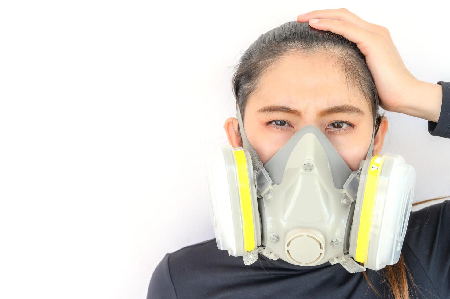 Portrait of young Asian woman wearing gas mask for protect smog bad air pollution or toxic. Air pollution has been associated with diseases of the heart and lungs, cancers and other health problems. photo
