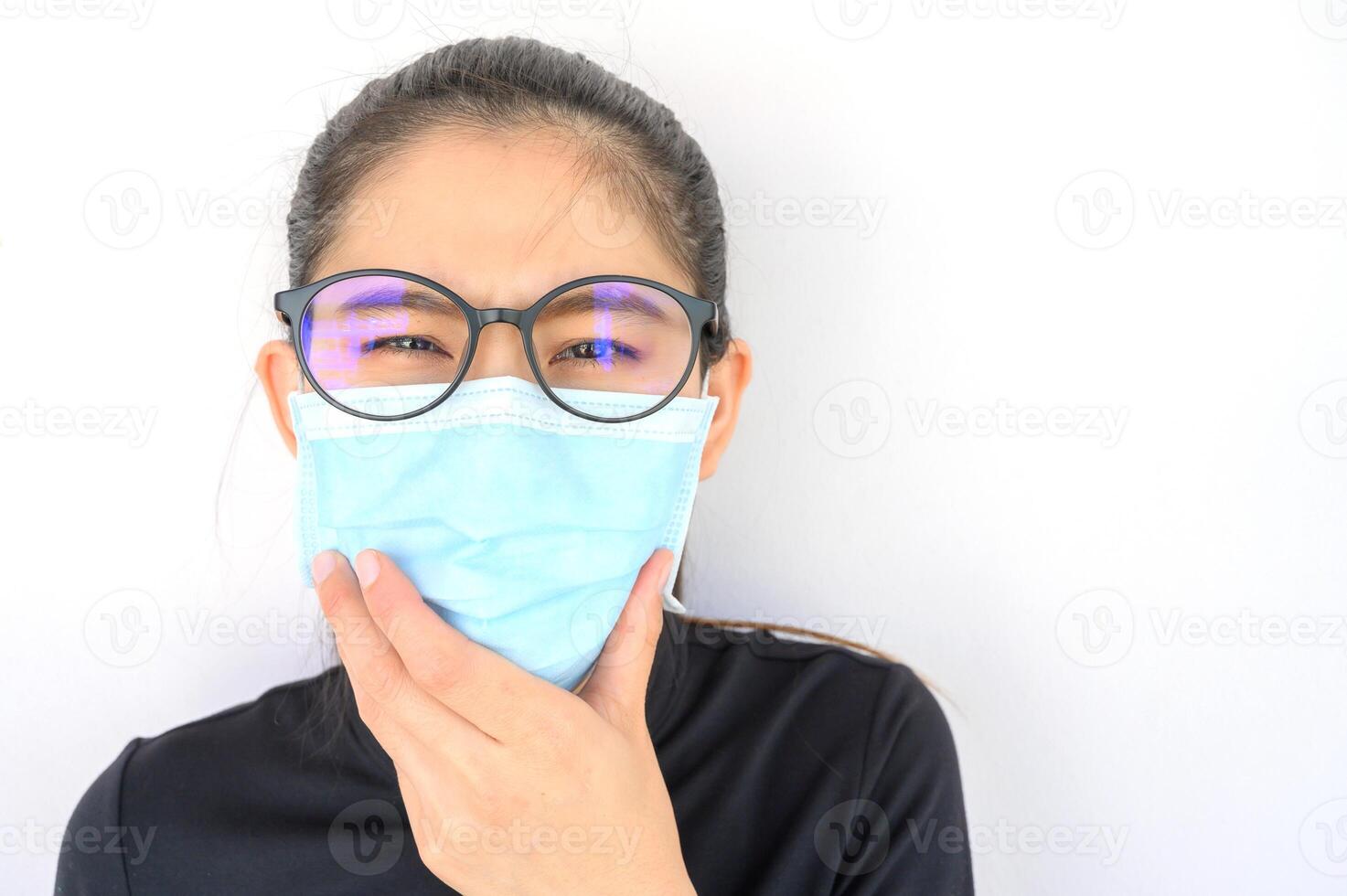Close up of young Asian woman coughing and wearing mask for protect bad air pollution. Air pollution has been associated with diseases of the heart and lungs, cancers and other health problems. photo
