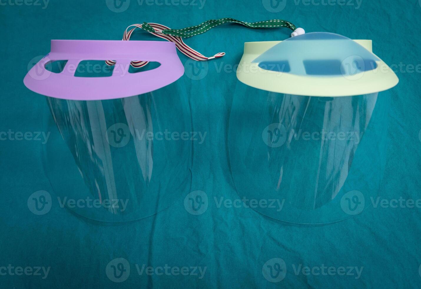 Twin plastic protective face shield preparing for use in operating room in hospital. Face shield is a device to protect the wearer's face from objects, chemical or even virus diseases. photo